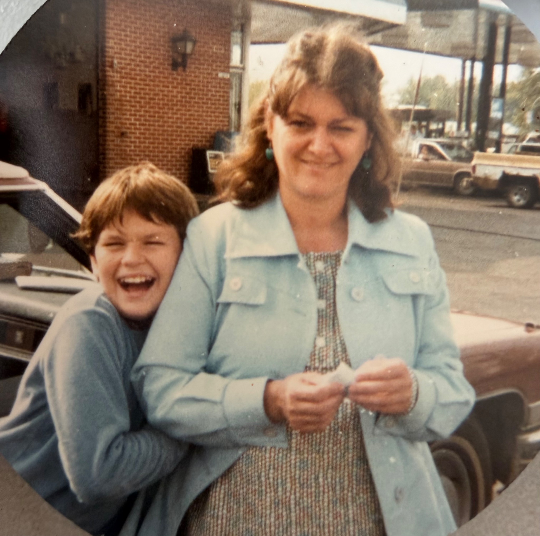 A young Jameson laughing beside his mother